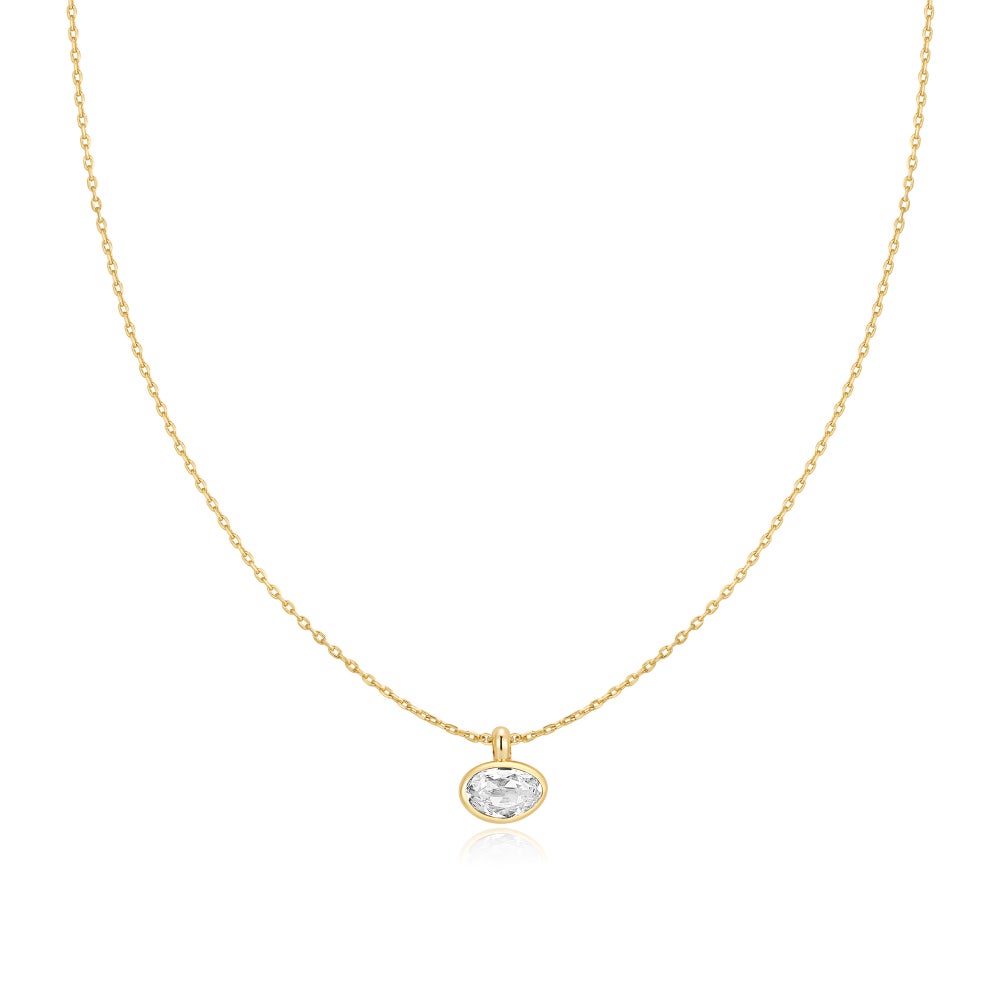 A gold chain featuring a fancy cut cubic zirconia in a bezel-set, pebble-like pendant on a white background