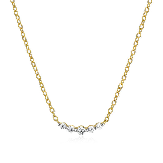 A gold necklace with five graduated diamonds on a curved bar on a white background