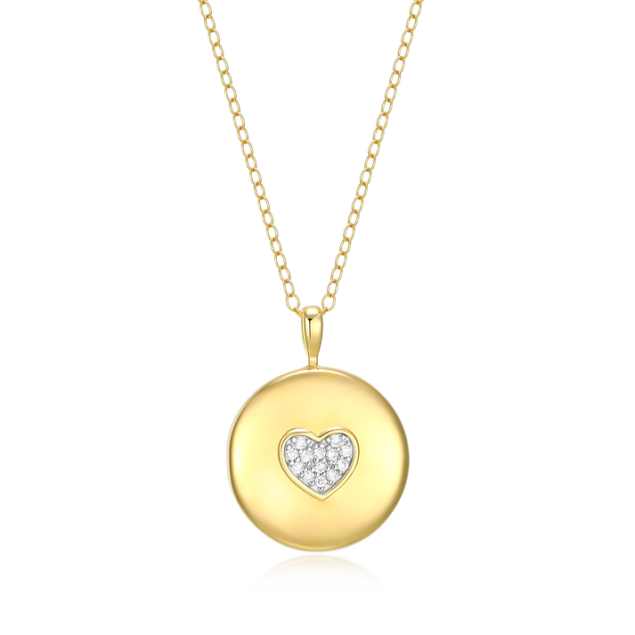A round gold locket with a heart at the center composed of small diamonds on a white background
