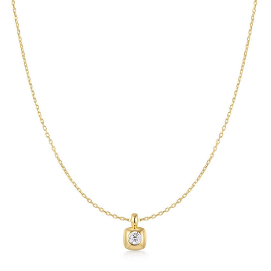 yellow gold plated pendant on a chain with a clear stone on a white bacground