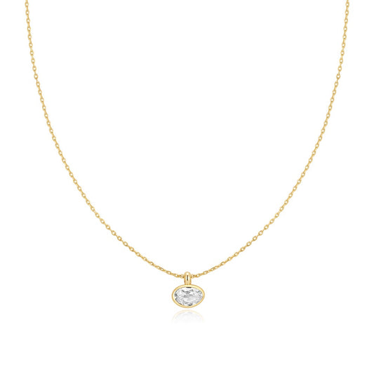 A gold chain featuring a fancy cut cubic zirconia in a bezel-set, pebble-like pendant on a white background